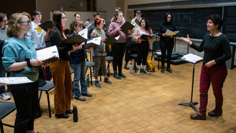 A choir of university students rehearses.