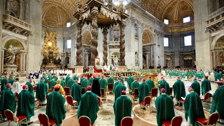 The pope leads bishops in mass inside a church.