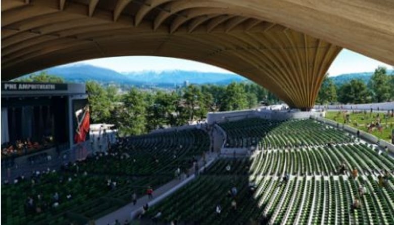 Rows of seats stretch forward to the stage under the free-span timber roof structure of the new PNE amphitheatre.