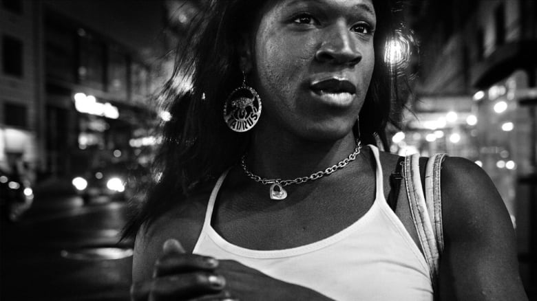 Still frame from the film Stroll. Black-and-white shot of a Black trans woman.