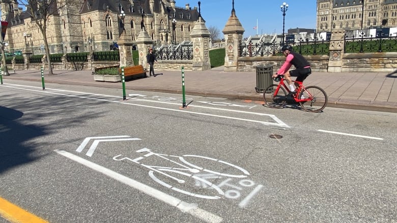 A cyclist uses a freshly painted bike lane on a downtown city street.