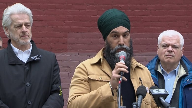 Federal NDP Leader Jagmeet Singh speaks at the National Day of Mourning event in Toronto. MPP Chris Glover is on his left, MPP Peter Tabuns is on his right.