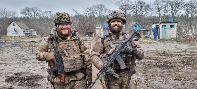 Two people are pictured in military uniforms