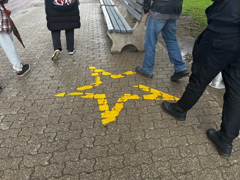 A star can be seen painted on the sidewalk. 