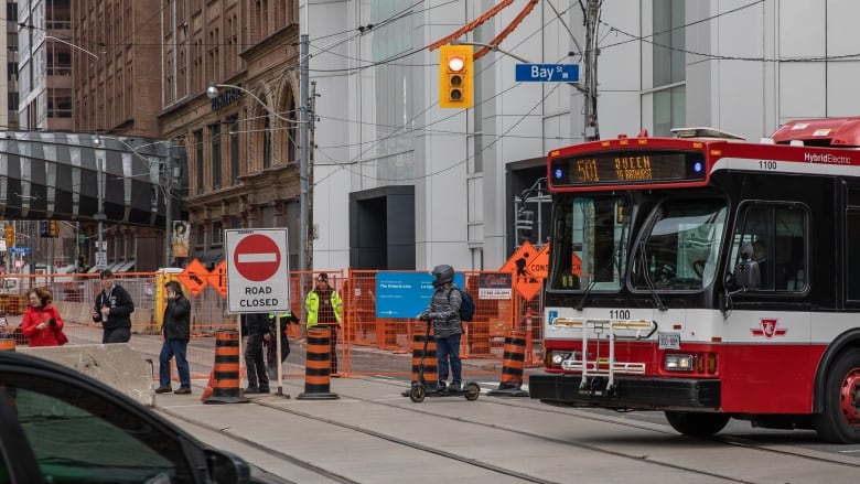 Drivers and transit riders in downtown Toronto navigate a roadway closure on Queen Street between Bay and Victoria streets for the next four-and-a-half years to accommodate construction of the Ontario Line's future Queen Station. Picture taken on May 1, 2023.