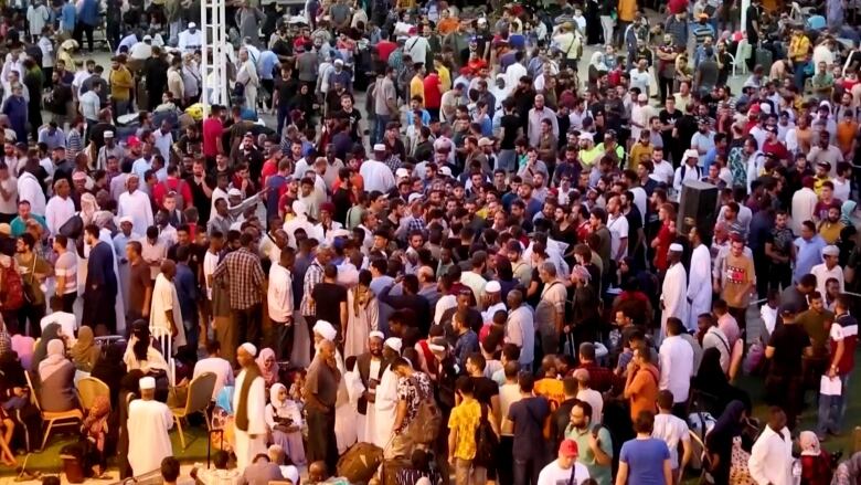 People gather in Port Sudan as they wait to be evacuated out of Sudan.