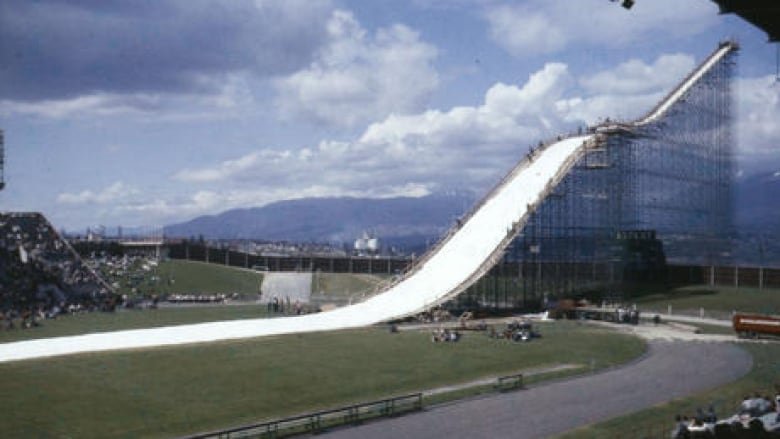 A large artificial ski hill is seen in a stadium.