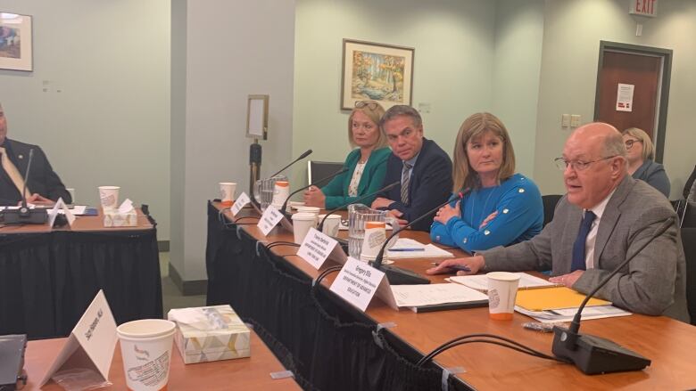 A group of people sit at a table.