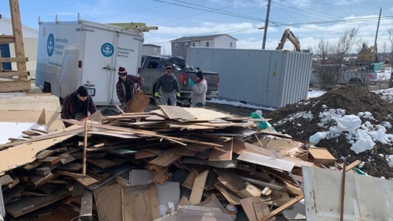 Mennonite Volunteers helping remove debris from Glace Bay home. 