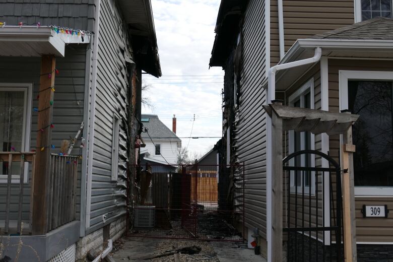 A view of two homes with significant fire damage. 