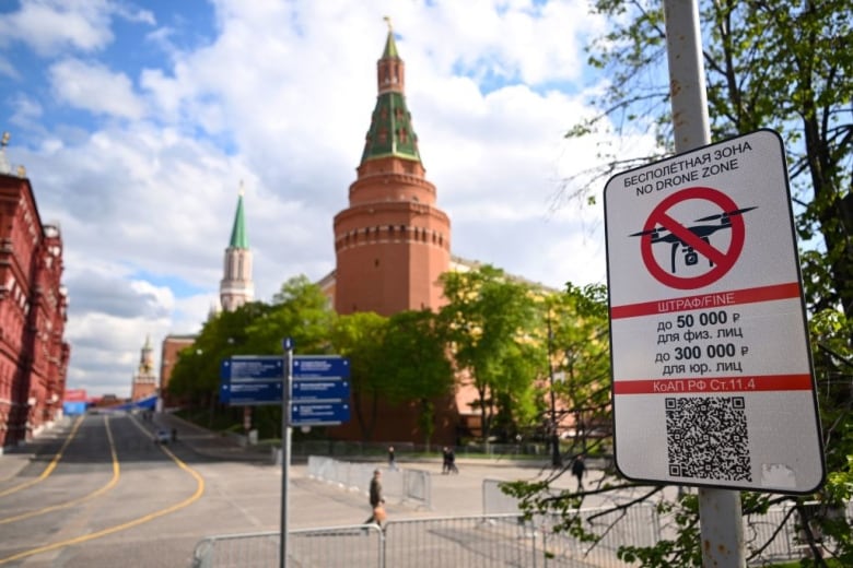 A sign in Russian and English warns of fines for flying drones near the Kremlin in Moscow, Russia.