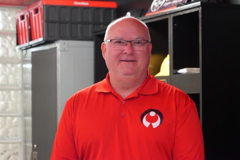 A man wearing a bright red shirt.