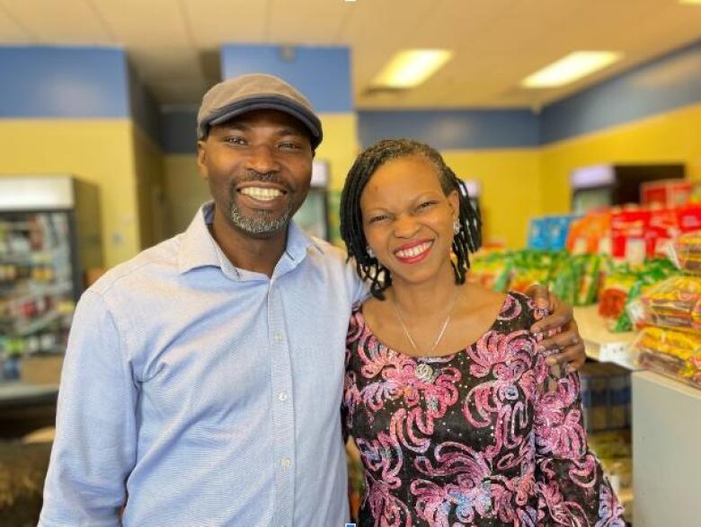 A man and a woman standing side by side inside an African store