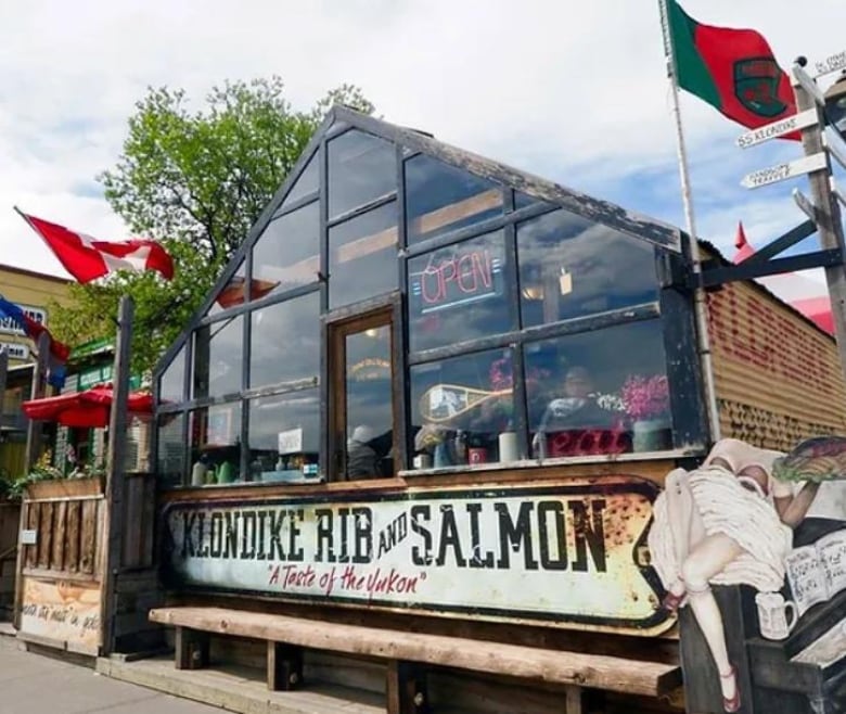 The outside of a glass-fronted restaurant building with the sign, 'Klondike Rib & Salmon.'