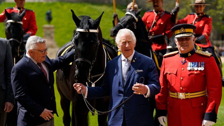 King Charles is pictured with a new horse, Noble.