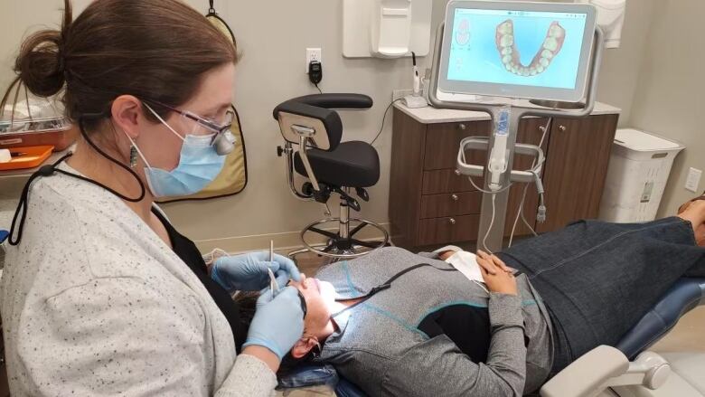 Dentist working on patient. 