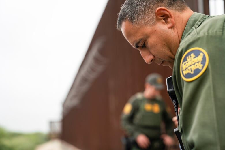 A U.S. Border Patrol agent begins the intake process for migrants from Colombia near the port of entry in Hidalgo Hidalgo, Texas, Thursday, May 4, 2023.