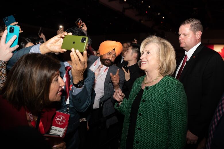 A number of Liberal supporters try to take photos of former U.S. Secretary of State Hillary Clinton.