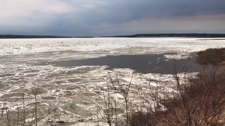 A wide river with ice and water visible.