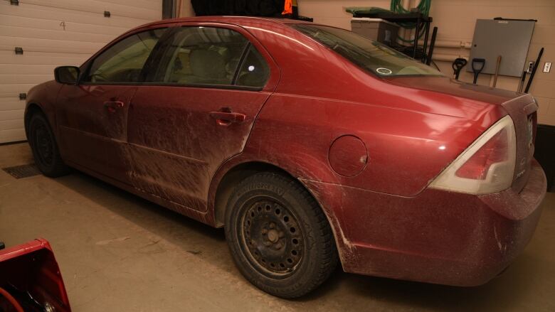 A red car parked in a garage.