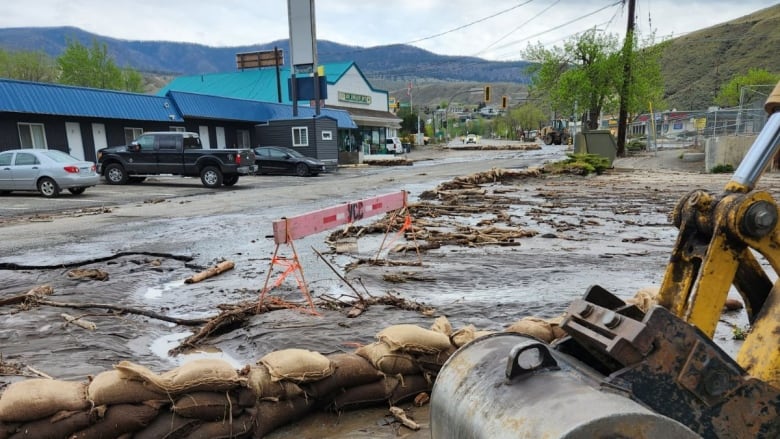 A washed out street with debris and sandbags due to flooding in Cache Creek B.C.