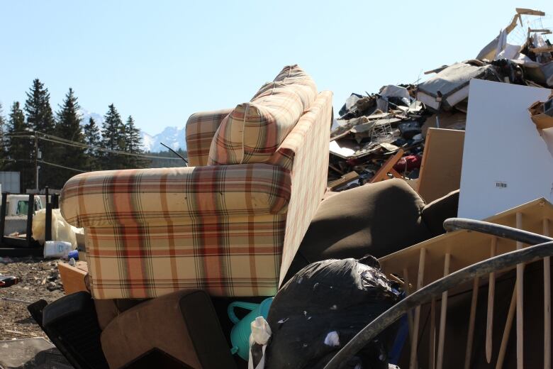 A couch is pictured atop a sundry pile destined for the landfill at the Banff waste transfer station.