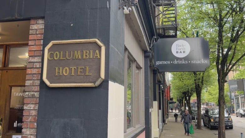 A sign on the side of a building says Columbia Hotel.