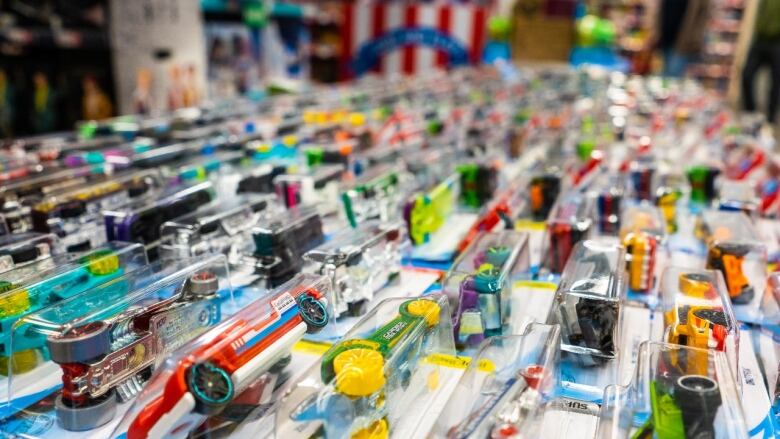 A large number of toy cars in blister packs on display.