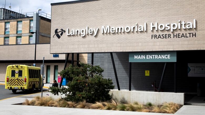 A sign outside a hospital reads 'Langley Memorial Hospital - Fraser Health'.