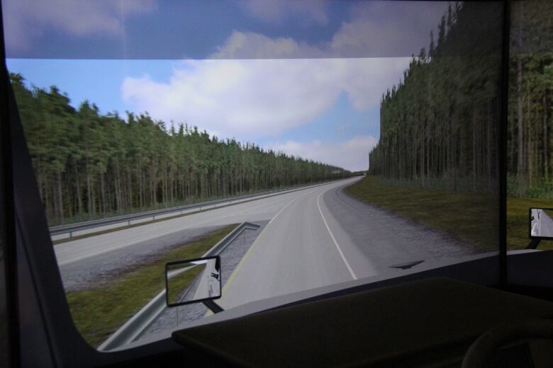 A view out a truck window as it looks to merge onto a highway.