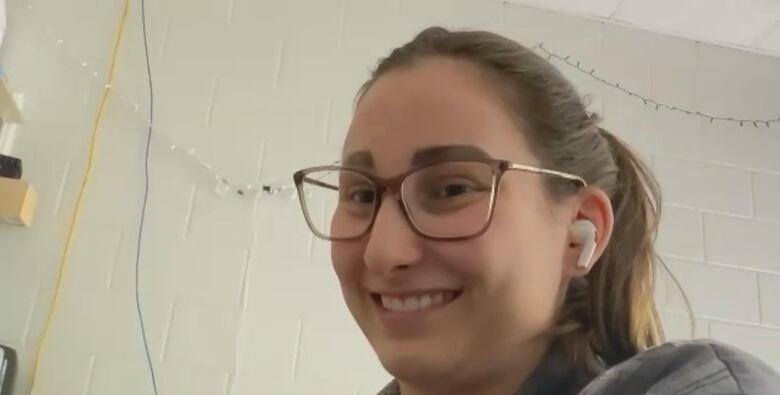 A woman with glasses on a video call