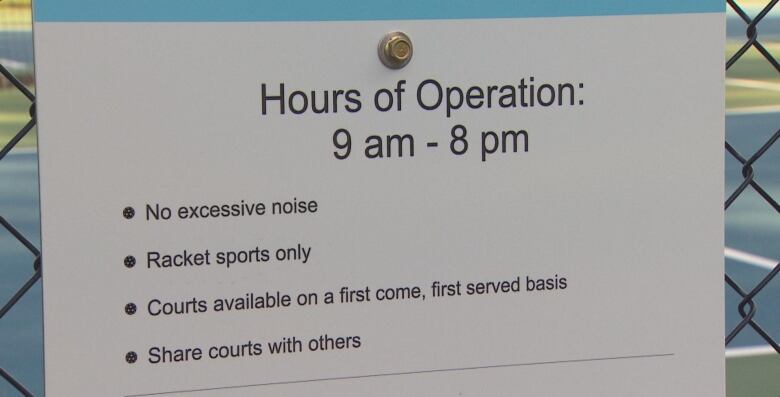 A sign that reads hours of operation 9am to 8pm No excessive noise racket sports only courts available on a first come, first served basis share courts with others