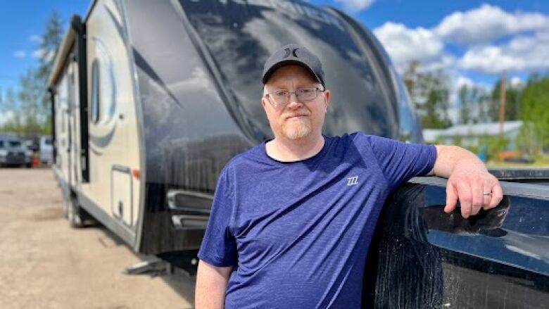 a man in front of a camper