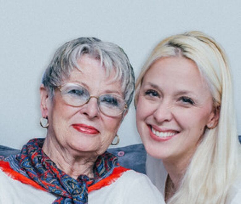 an older woman and her daughter smiling at the camera