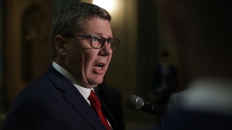 Premier Scott Moe speaks with media at the Saskatchewan legislature on May 15, 2023. 