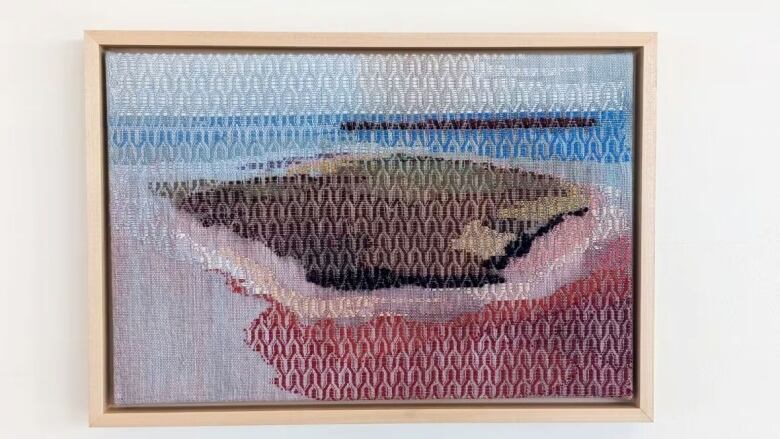 A piece of knitted art depicting the P.E.I. shoreline.