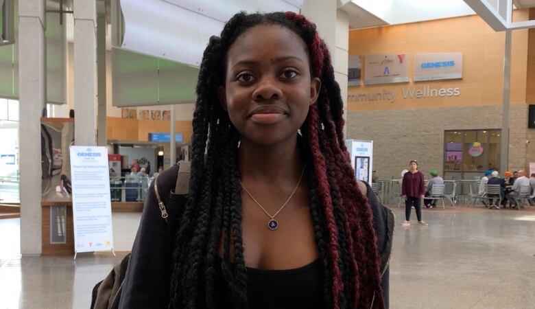 A teenage girl smiles for the camera.