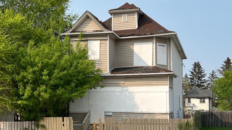 A house is seen boarded up after a fire.