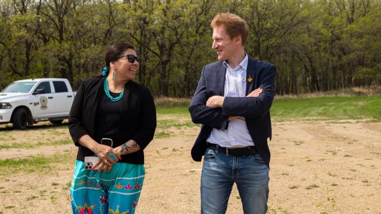 A woman and man smile at each other.