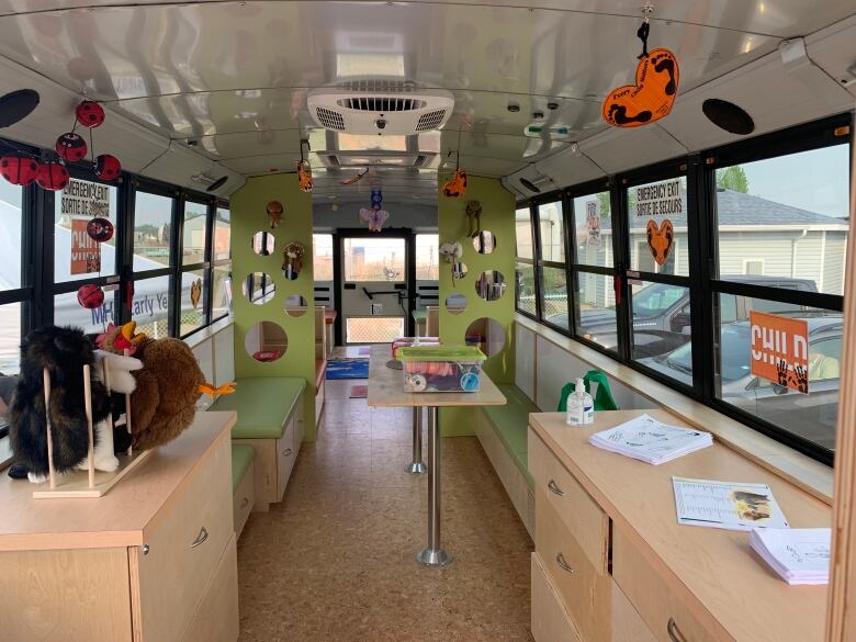 The inside of a bus has been renovated to include benches and tables to provide a playspace for preschoolers.