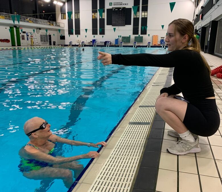 A woman swims in a pool.