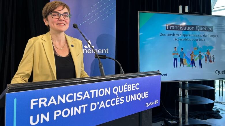 woman smiling at a podium.