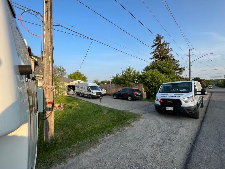 police cars and vans on driveway