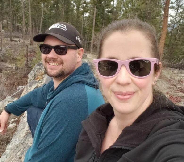 A white woman and a man pose for a selfie.