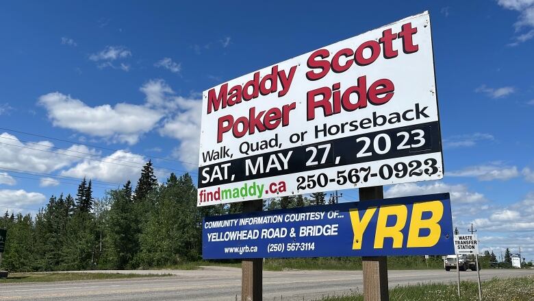 A billboard along a highway says: Maddy Scott Poker Ride. Walk, Quad or Horseback. Saturday, May 27, 2023. Along the bottom: findmaddy.ca: 250-567-0923.