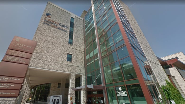 A view from the sidewalk, looking up at a building, with the name CancerCare.