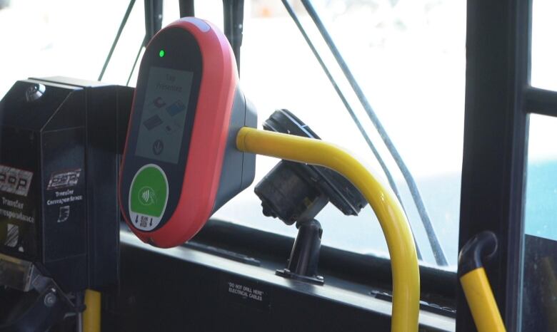 Red smartcard reader at the front of OC Transpo bus. 