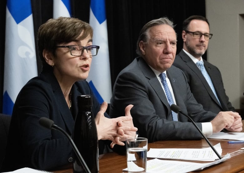 Quebec Immigration Minister Christine Frechette, left,  presents new programs on immigration at a news conference, Thursday, May 25, 2023 at the legislature in Quebec City. Quebec Premier Francois Legault, centre, and Quebec Minister Responsible for Canadian Relations and the Canadian Francophonie Jean-Francois Roberge look on. 