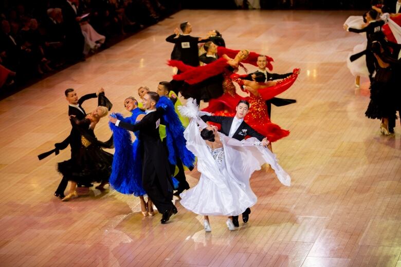 Groups of dancers perform the waltz at a venue in Blackpool, England.