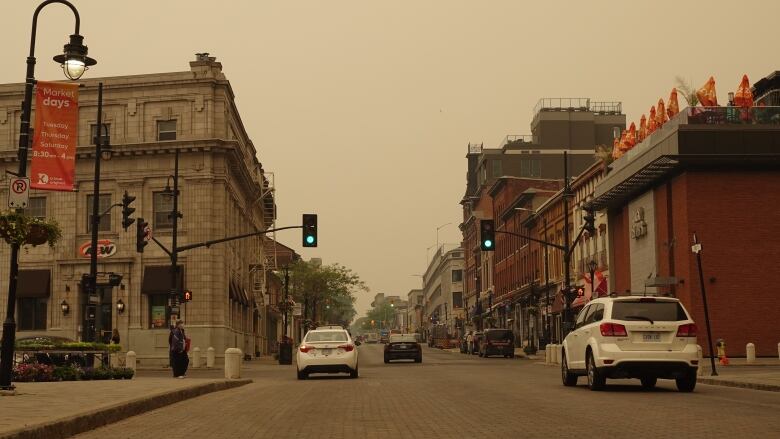 Brown smoke over a city street.